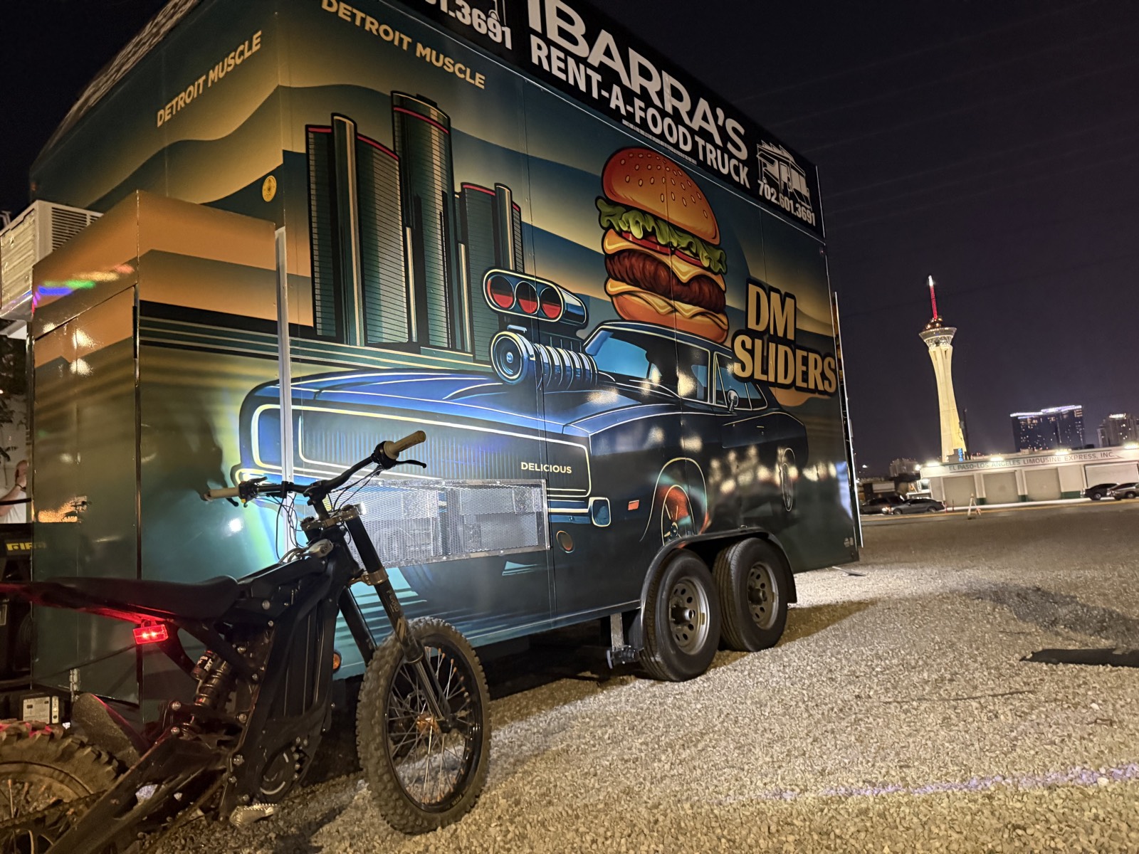 DM Sliders trailer at night in Las Vegas, with the Stratosphere behind it